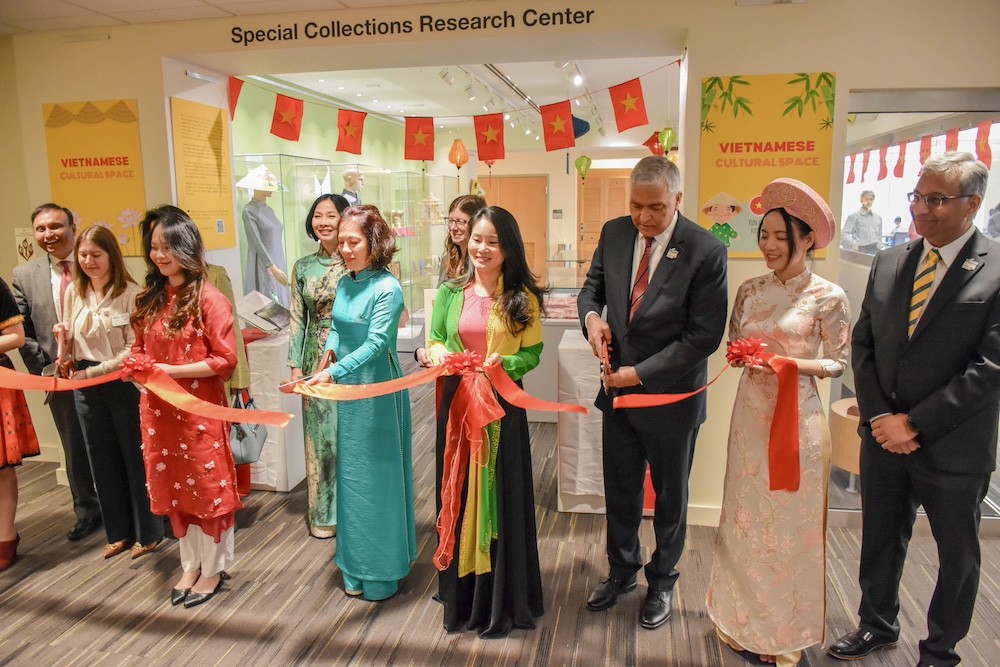 group cuts ribbon on exhibit