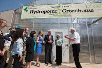 people standing outside greenhouse