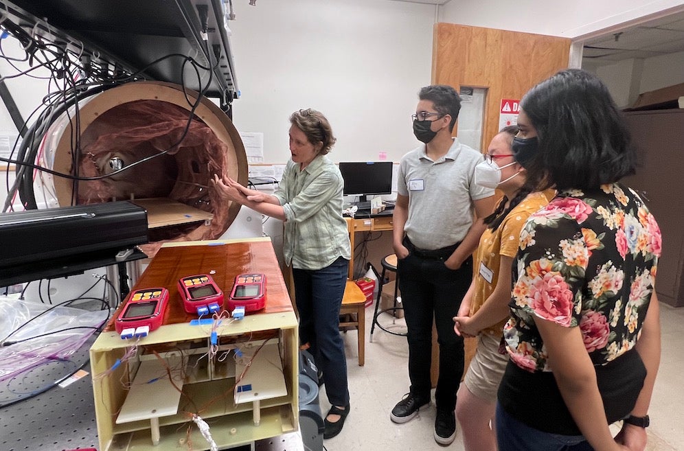 masked students in a lab with a researcher