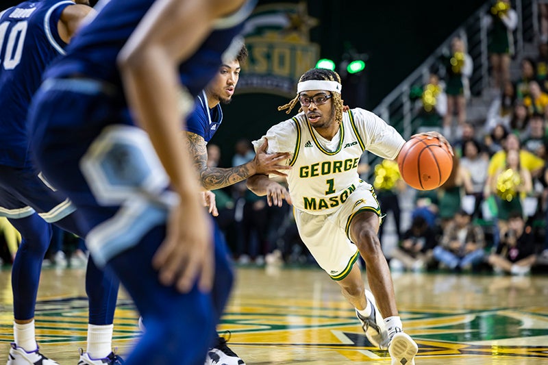 Ronald Polite III drives to the basket against Rhode Island
