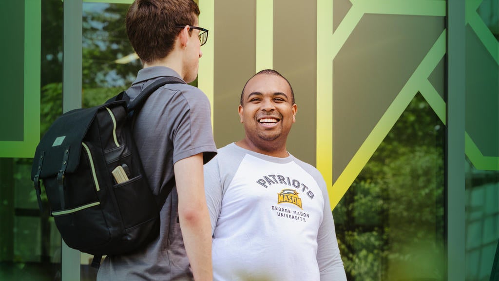Mason graduate student Xavier Clark smiles outside the MIX on the Fairfax campus.