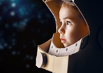 Child in cardboard astronaut helmet