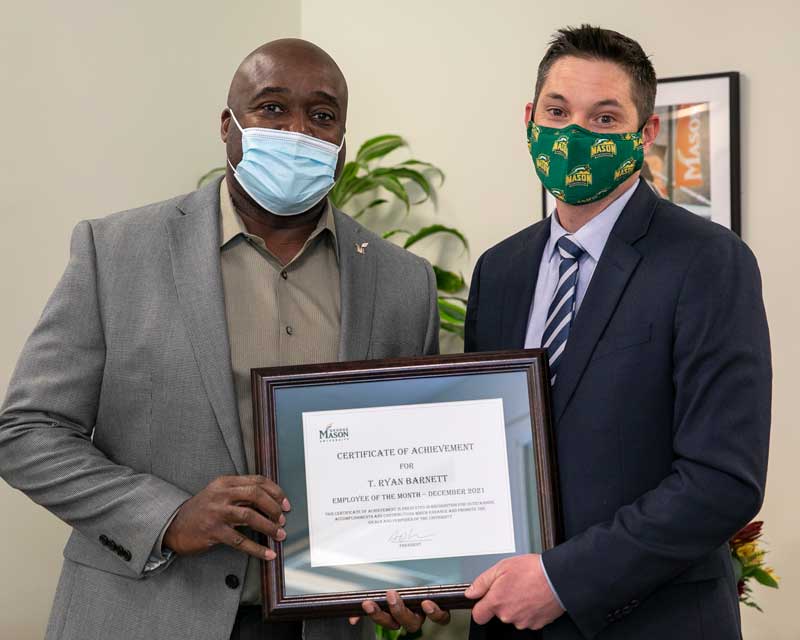 Gregory Washington and Ryan Barnett pose for a photo during the awarding of Mason's December 2021 Employee of the Month. 