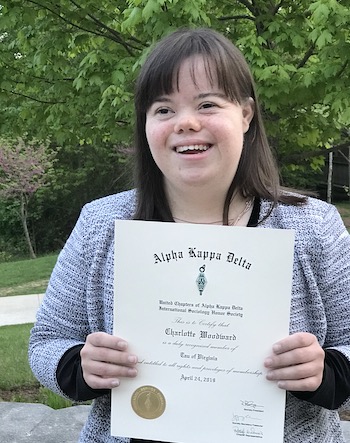 Charlotte Woodward outside with certificate
