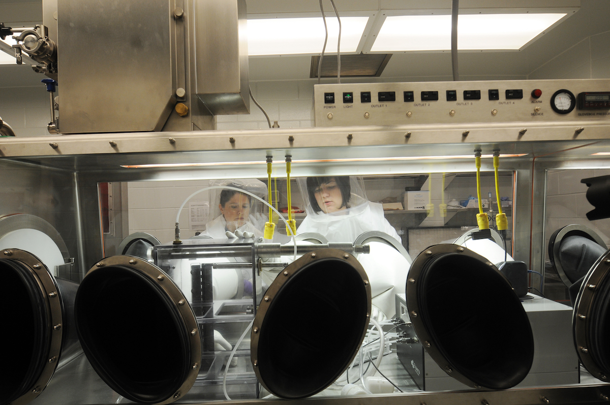 women in protective gear in a lab
