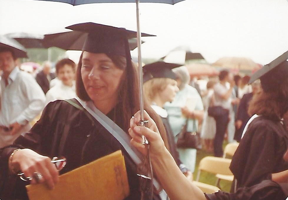 woman in black cap and gown under an umbrella