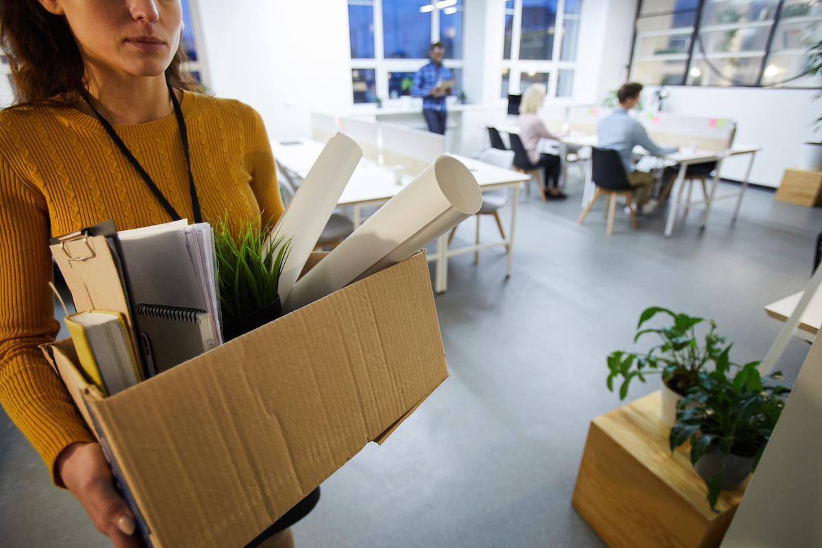 woman leaving office with box