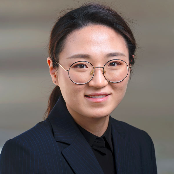 Ningshi Yao wears a navy-blue suit and glasses in her faculty profile for the Department of Electrical and Computer Engineering