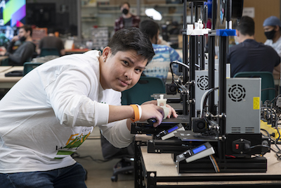 student uses 3d printer in the MIX