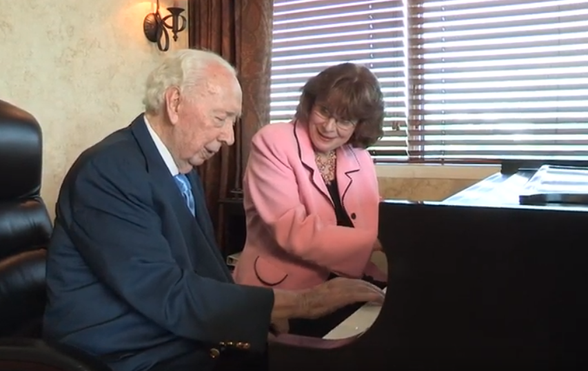 Sid Dewberry and Linda Monson sit and play a duet on the piano.