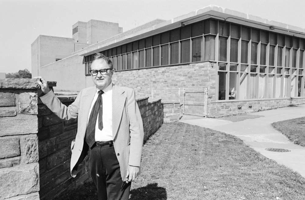 Dean Ralph Novell standing in front of the George Mason University School of Law building in the late 1970s.