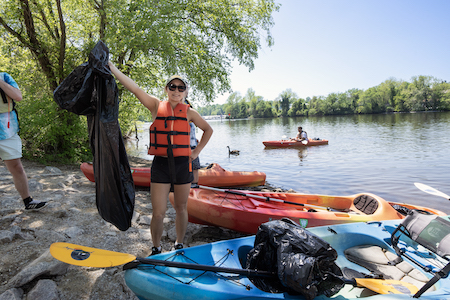 students clean up trash at Occoquan Regional Park using kayaks