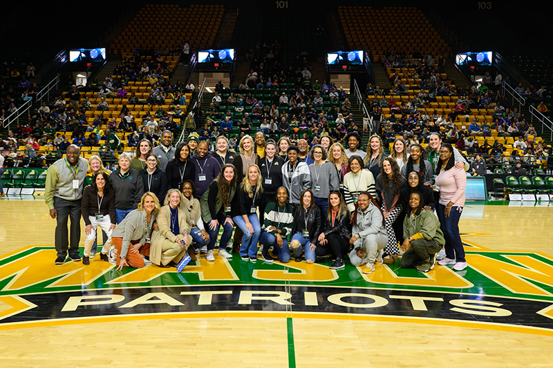 Women's basketball alumni gather at center court
