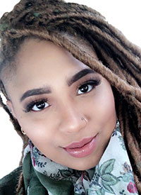 Mason assistant professor Brittany Johnson has brown locs and a light scarf in her profile
