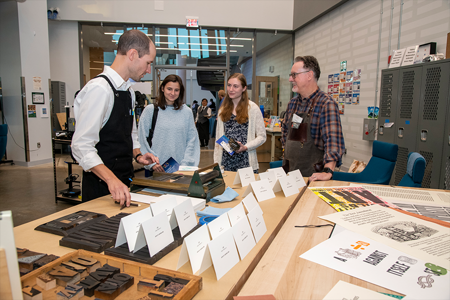 Faculty from the School of Art walk guests through the interactive printing station in the Mason Innovation Exchange (MIX) at ARTS! By George 2022. (Photo by Cable Risdon Photography)