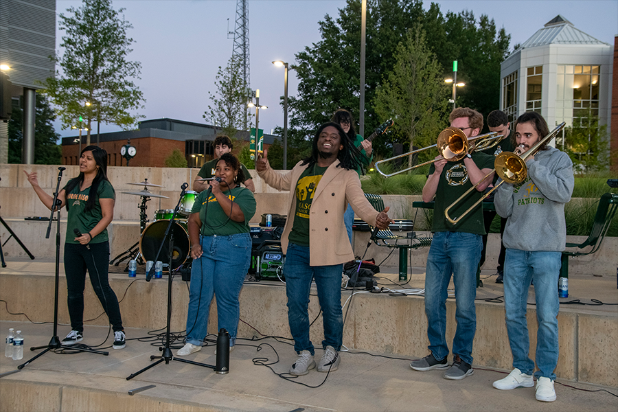 Members of the Green Machine Pep Band perform outside Horizon Hall at ARTS! By George 2022. (Photo by Cable Risdon Photography)