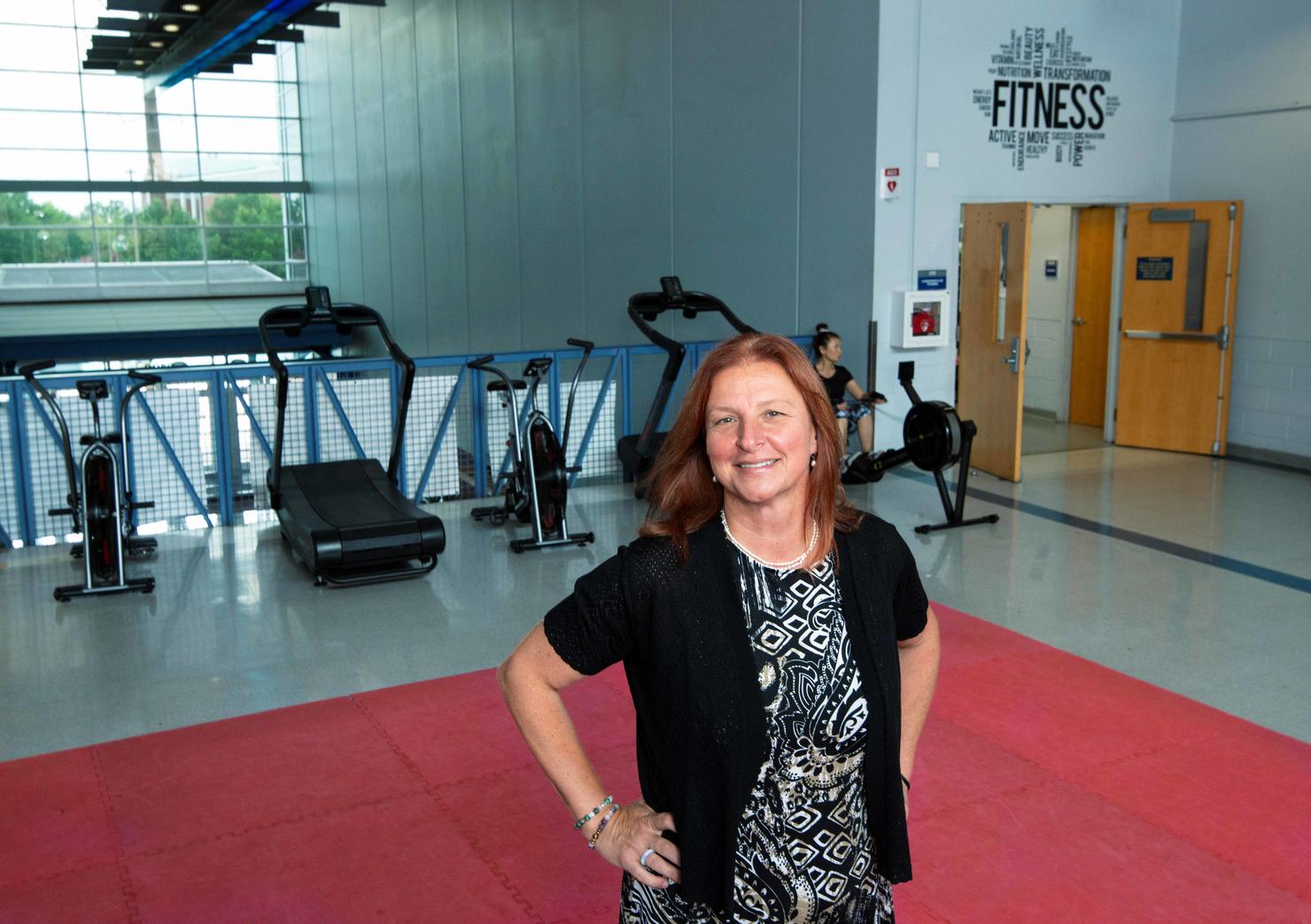 Olga O'Brien stands in front of exercise machines at the Freedom Aquatic & Fitness Center