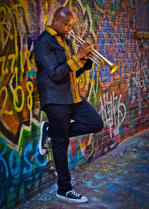 Trumpeter Sean Jones plays in front of graffiti wall