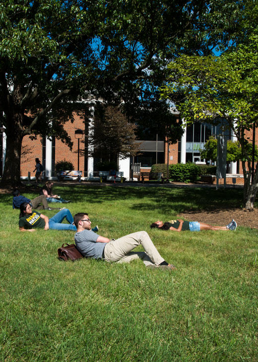 Mason students relax on the lawn on the Fairfax Campus