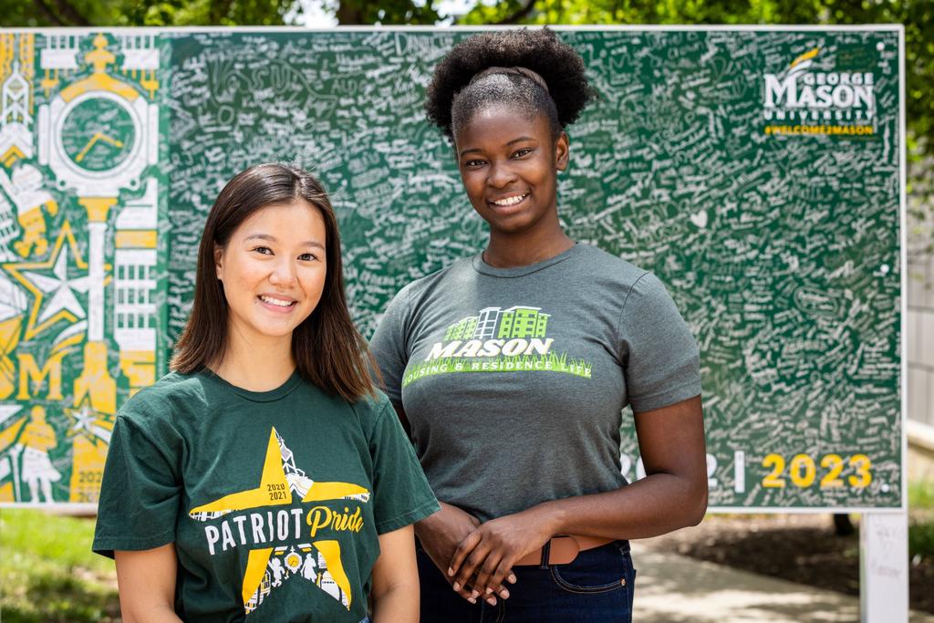 2022-2023 Student Body President Sophia Nguyen, left, and Vice President Celine Apenteng, right, standing in front of the Class of 2023 sign.