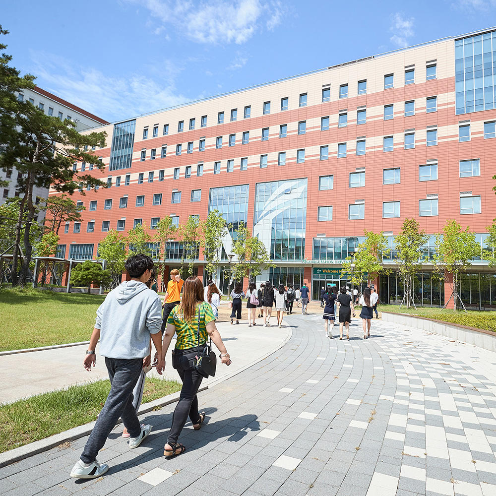 Students walk towards Mason's Korea location