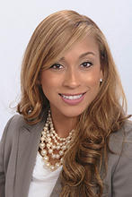 Kelly Knight is wearing a white blouse, tan blazer and multi-strand necklace