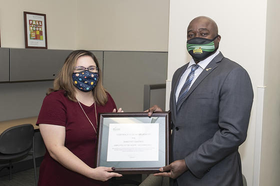 Dorothy Hayden receives the November Employee of the Month award from Mason President Gregory Washington at the Fairfax Campus.