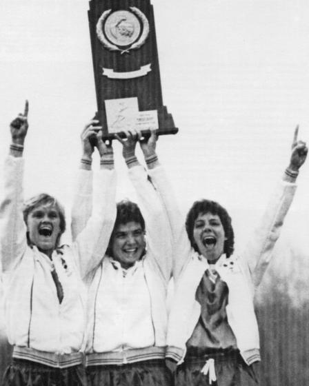 bw photo of three woman holding trophy