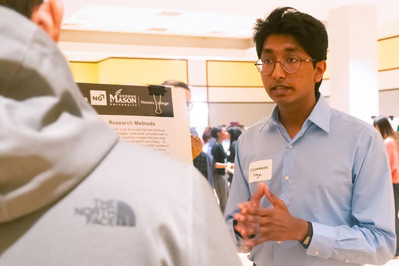 An honors college student describes their project at the Honors College Research Exhibition
