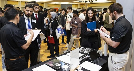 Students talking to employers in the crowded career fair