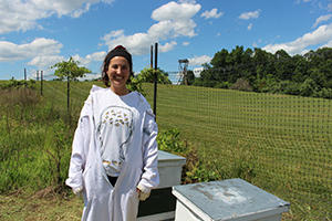 Mason alum Alessandra Castaneda volunteering with the Honey Bee Initiative