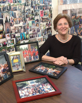 Hortensia Cadenas in her office with photos of the the Early Identification Program’s many graduates.