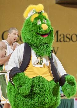 Former Mason mascot Gunston, a fuzzy green monster-like creature, at a basketball game