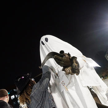 George Mason IV statue decorated in a white sheet with eye holes to resemble a ghost