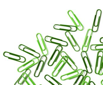 Green paper clips scattered